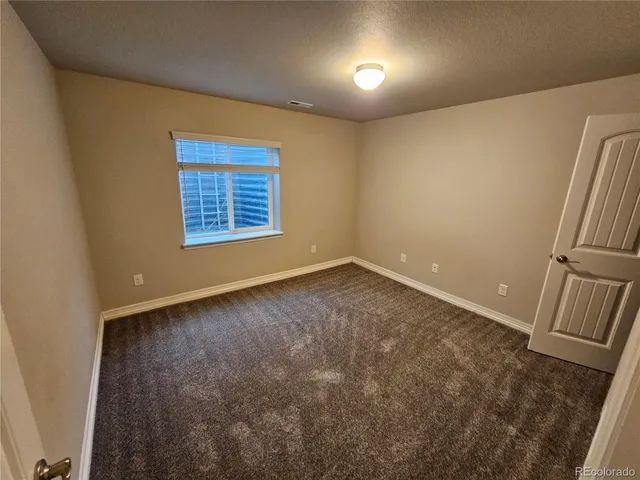 an empty room with a fireplace