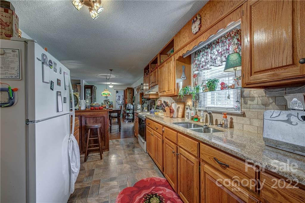 5487 State Rd S-46-557 Clover, SC 29710 - Photo 15 of 32 a kitchen with refrigerator cabinets and a sink