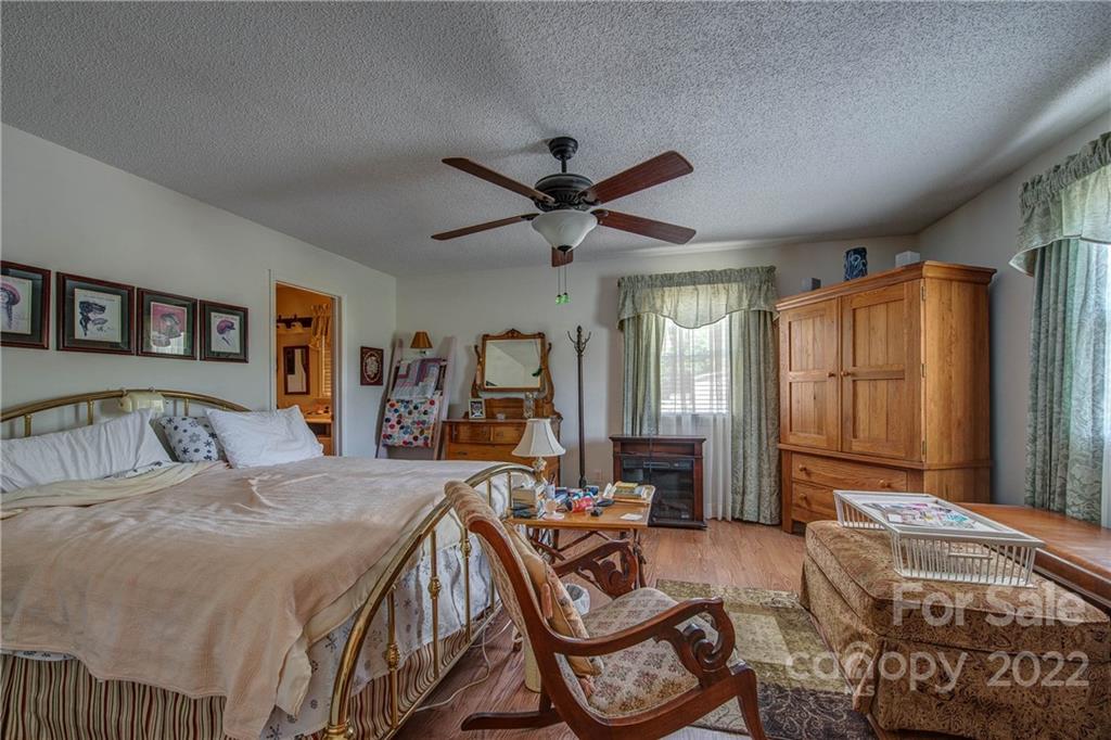 5487 State Rd S-46-557 Clover, SC 29710 - Photo 19 of 32 a bedroom with a bed and a chandelier