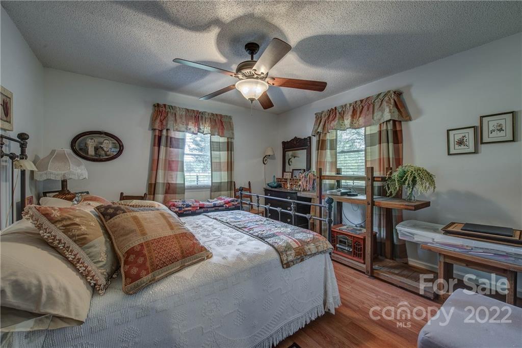 5487 State Rd S-46-557 Clover, SC 29710 - Photo 22 of 32 a bedroom with a bed and a chandelier