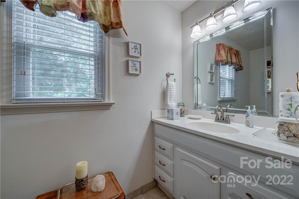 5487 State Rd S-46-557 Clover, SC 29710 - Photo 25 of 32 a bathroom with a sink vanity and a mirror