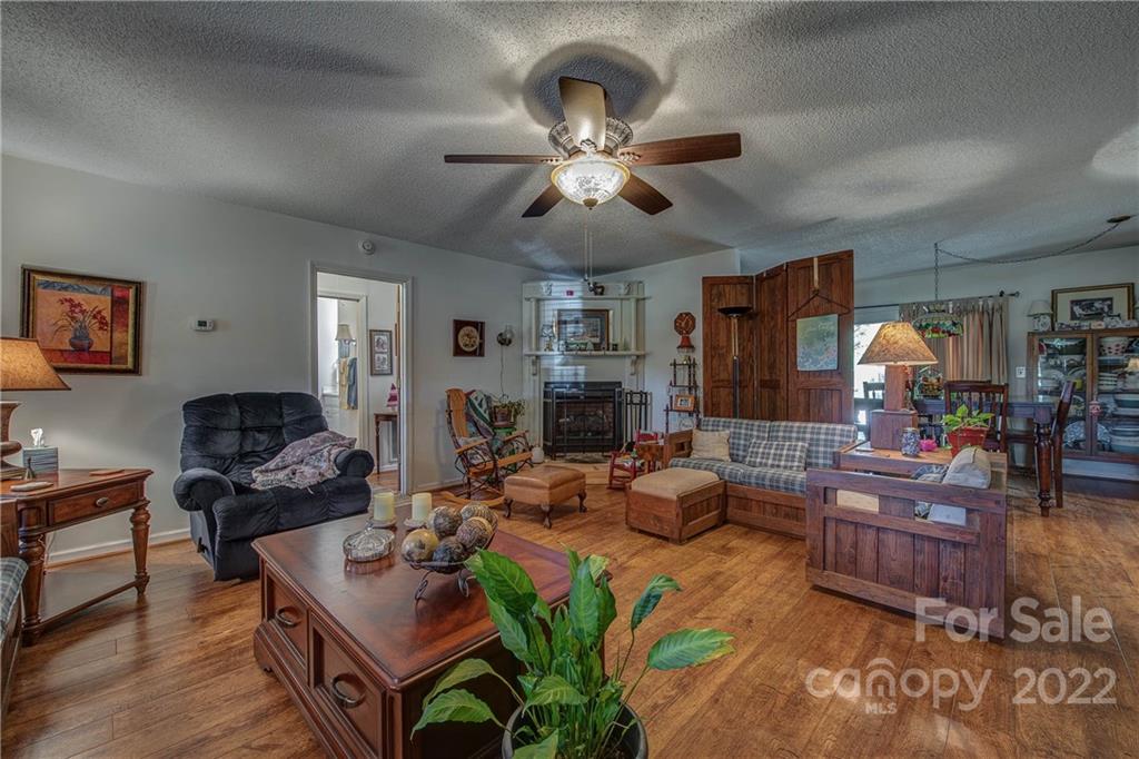 5487 State Rd S-46-557 Clover, SC 29710 - Photo 10 of 32 a living room with fireplace furniture and a wooden floor