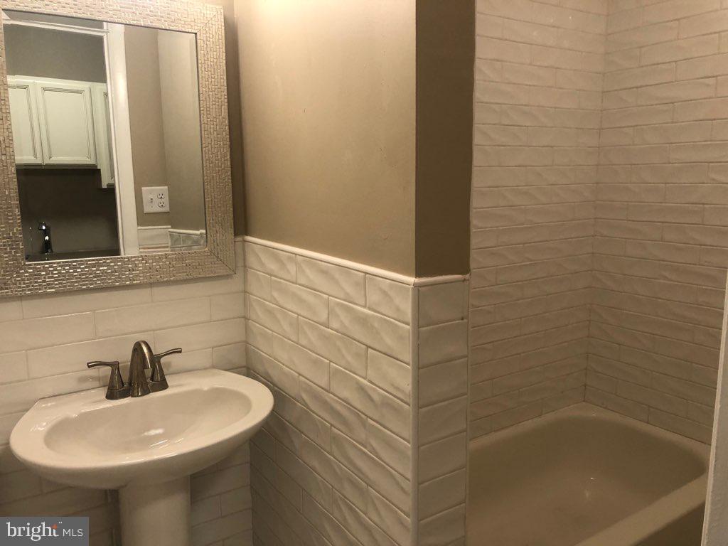101 East Broad Street, Unit 2 Quakertown, PA 18951 - Photo 4 of 8 a bathroom with a sink and a mirror