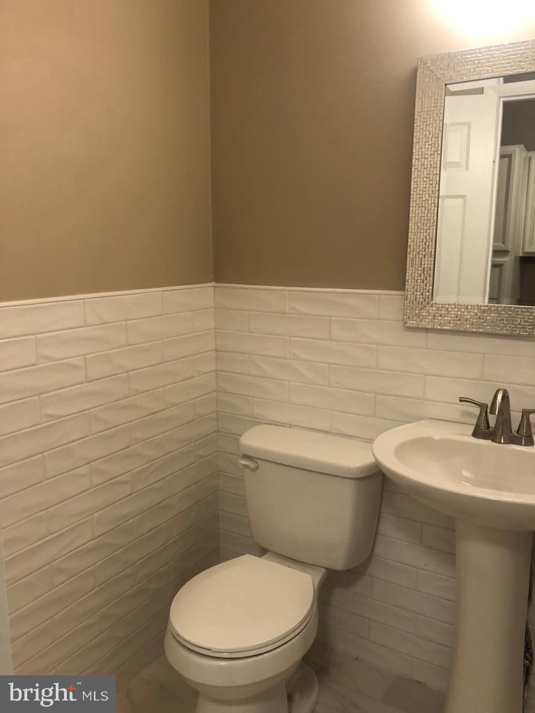 101 East Broad Street, Unit 2 Quakertown, PA 18951 - Photo 5 of 8 a bathroom with a toilet a sink and mirror