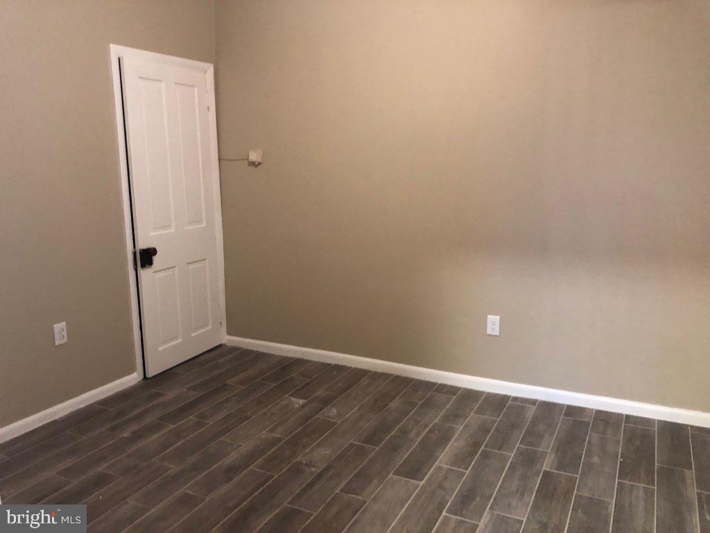 101 East Broad Street, Unit 2 Quakertown, PA 18951 - Photo 6 of 8 an empty room with wooden floor and closet