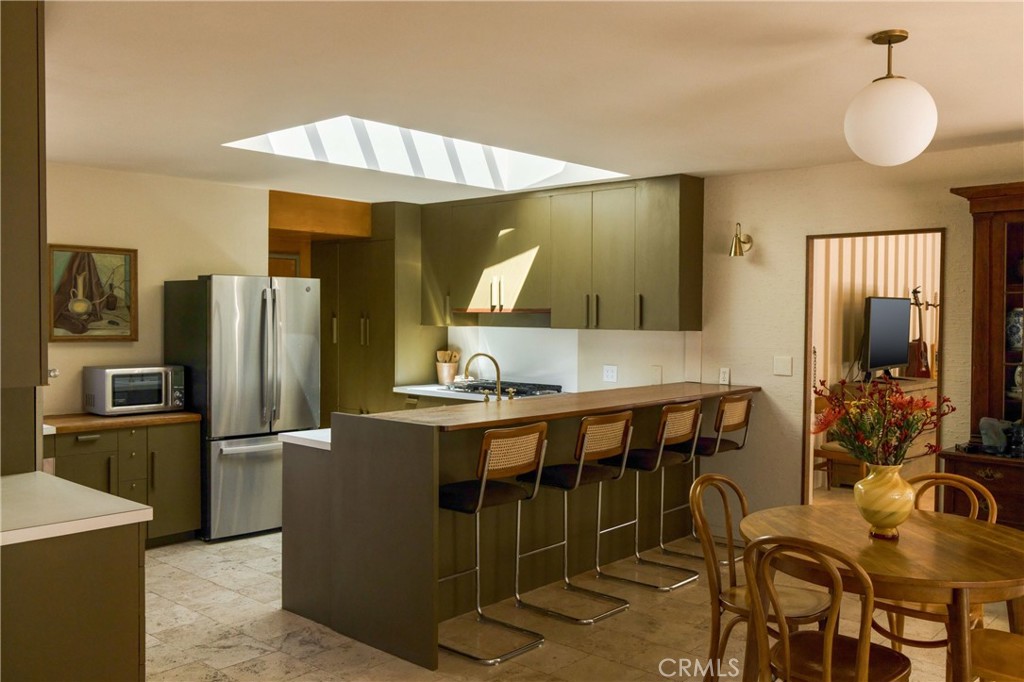 2278 Arroyo Drive Riverside, CA 92506 - Photo 29 of 75 a kitchen with stainless steel appliances granite countertop a sink refrigerator and cabinets