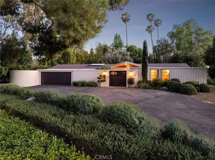 an front view of a house with a yard