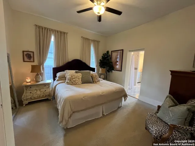 a spacious bedroom with a bed and window