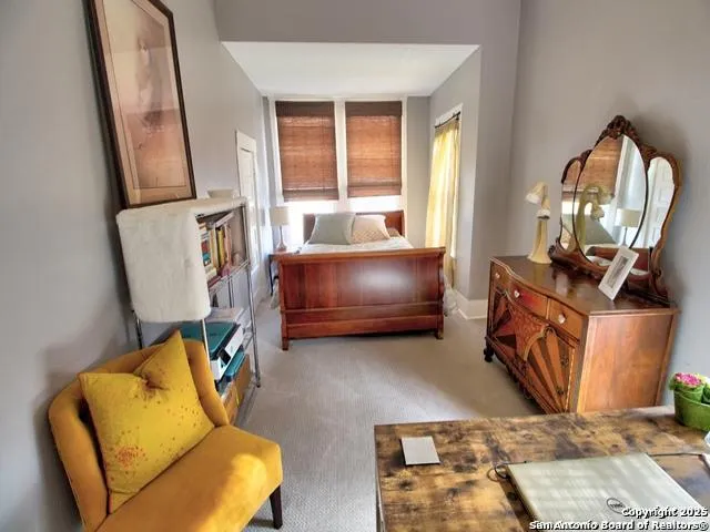 a living room with furniture and a mirror