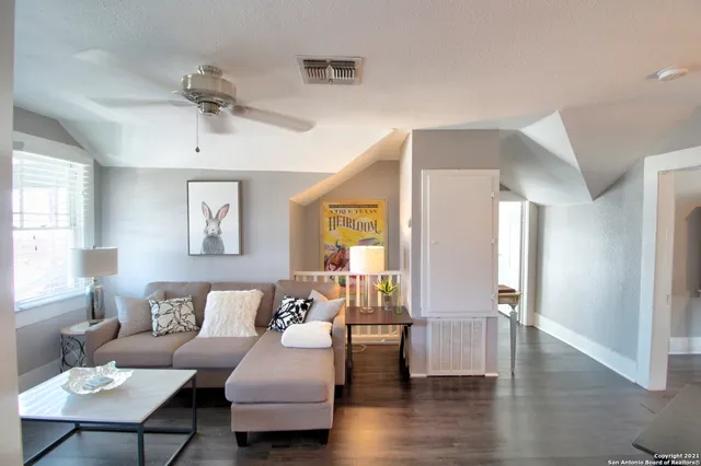 a living room with furniture and wooden floor