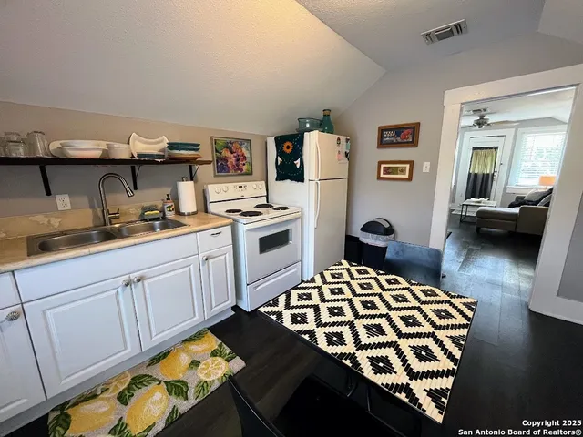 a kitchen with a sink stove and refrigerator
