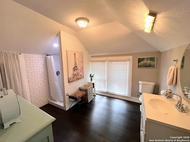 a view of a bedroom with furniture and wooden floor