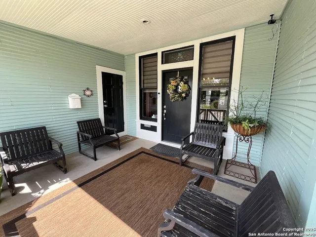a view of a house with a yard and sitting area