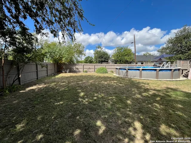 a view of a swimming pool with a patio
