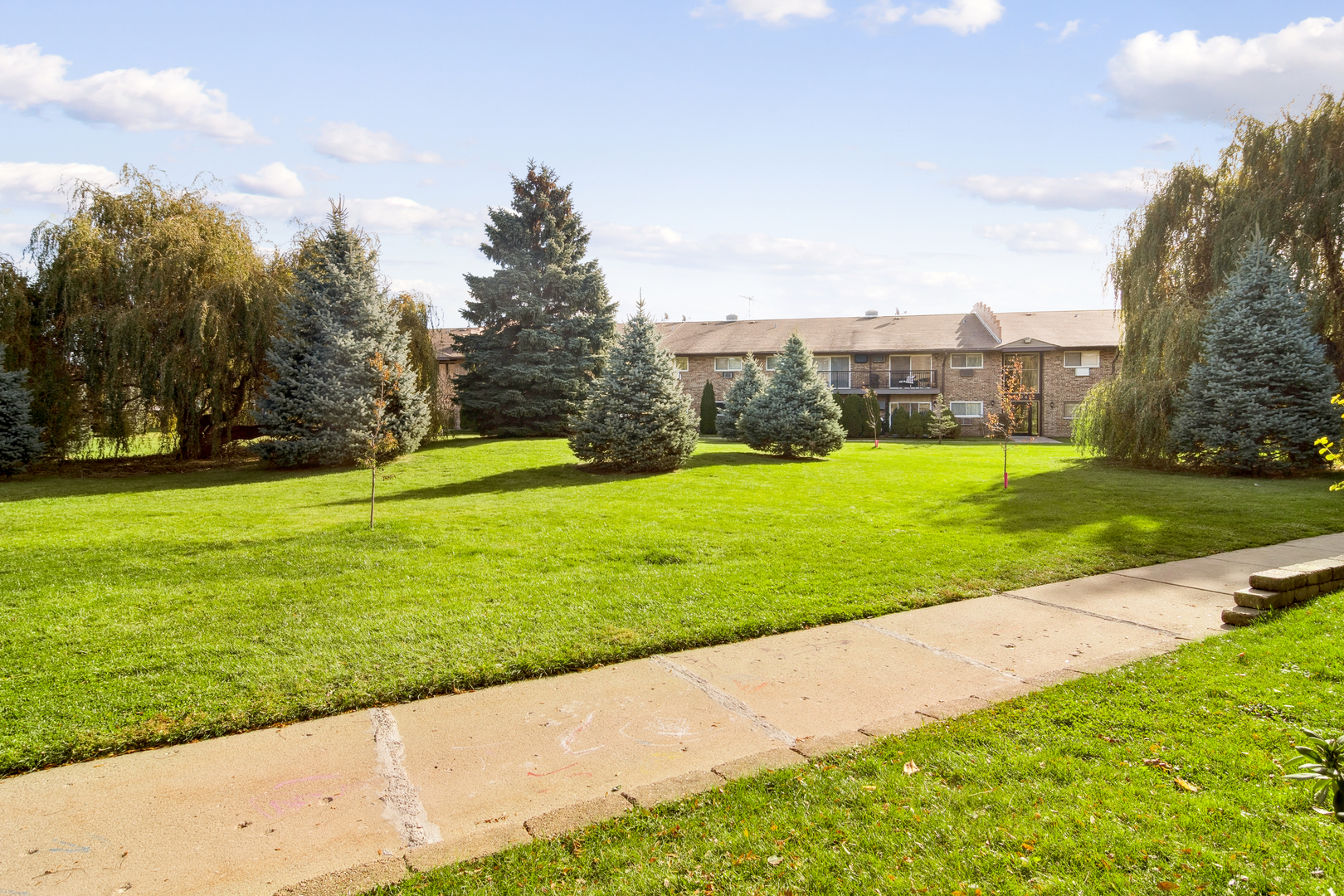 802 East Old Willow Road, Unit 113 Prospect Heights, IL 60070 - Photo 11 of 11 a view of a garden with a building in the background