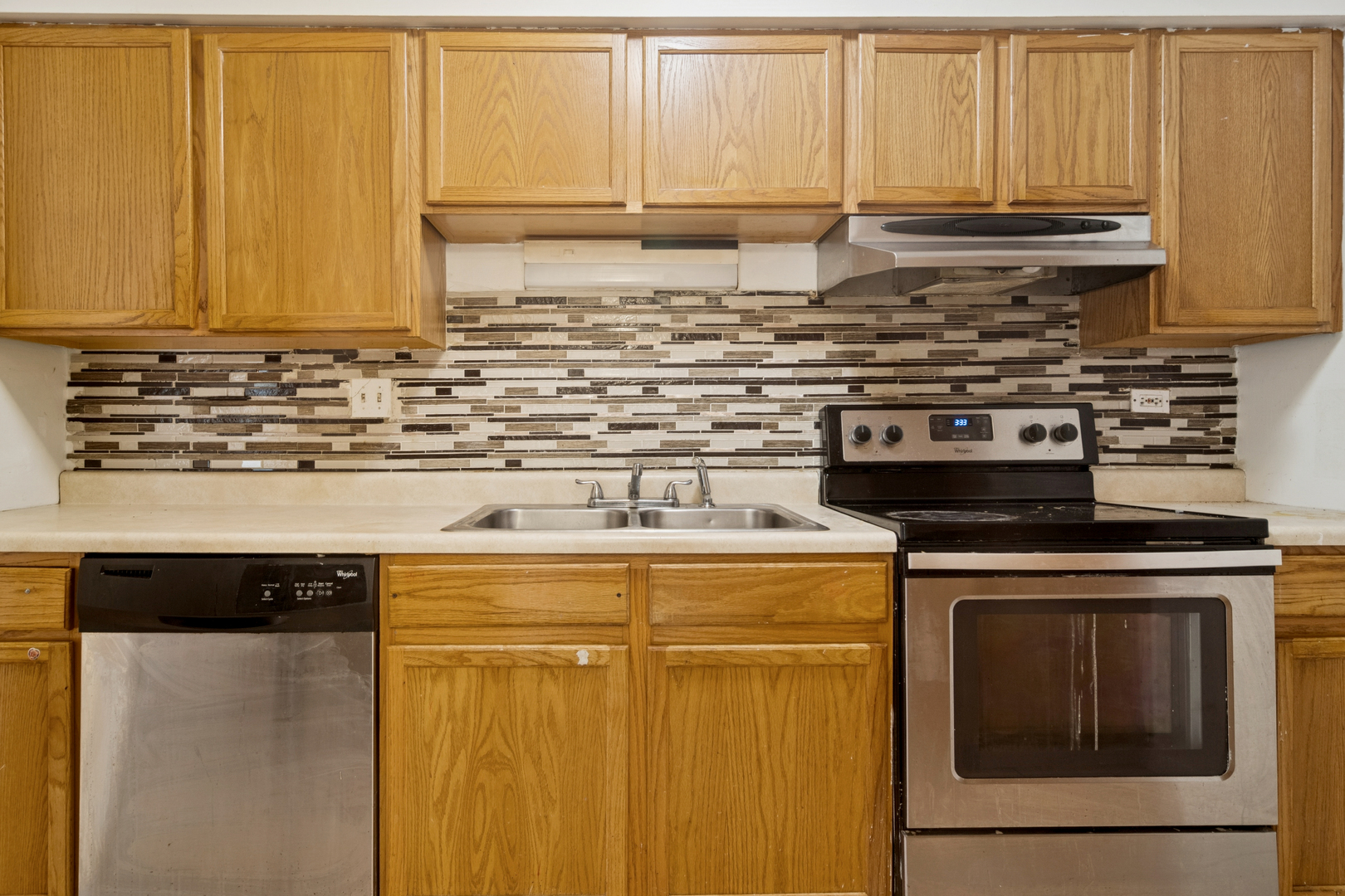 802 East Old Willow Road, Unit 113 Prospect Heights, IL 60070 - Photo 4 of 11 a kitchen with stainless steel appliances wooden cabinets and a sink