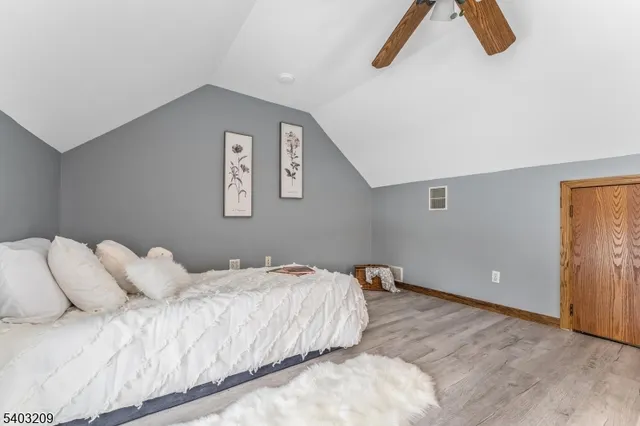 a bedroom with a bed and a lamp on desk