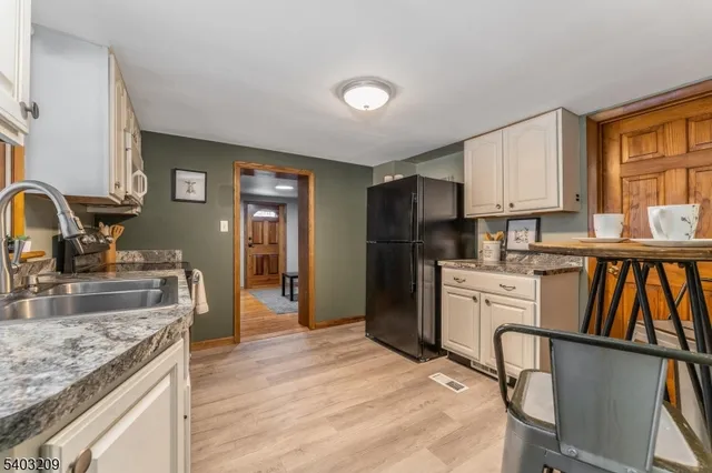 a kitchen with a refrigerator and a sink