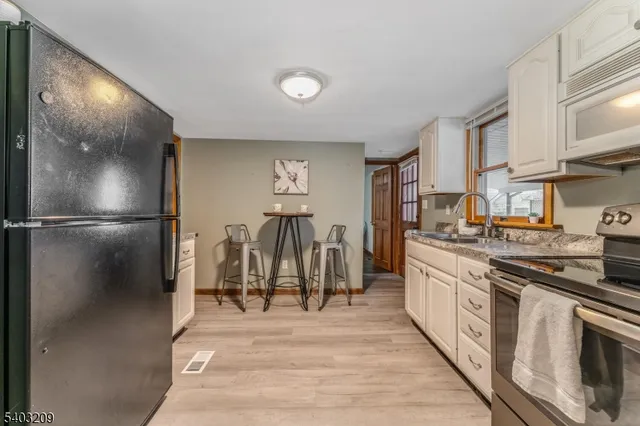 a kitchen with stainless steel appliances granite countertop a refrigerator and a stove