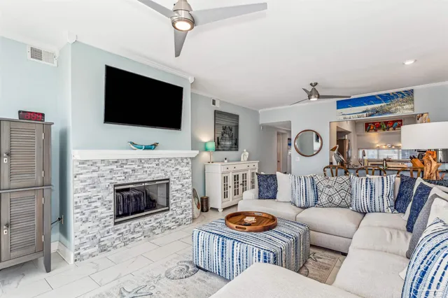 a living room with furniture a flat screen tv and a fireplace