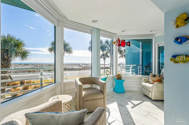 a living room with furniture and a floor to ceiling window