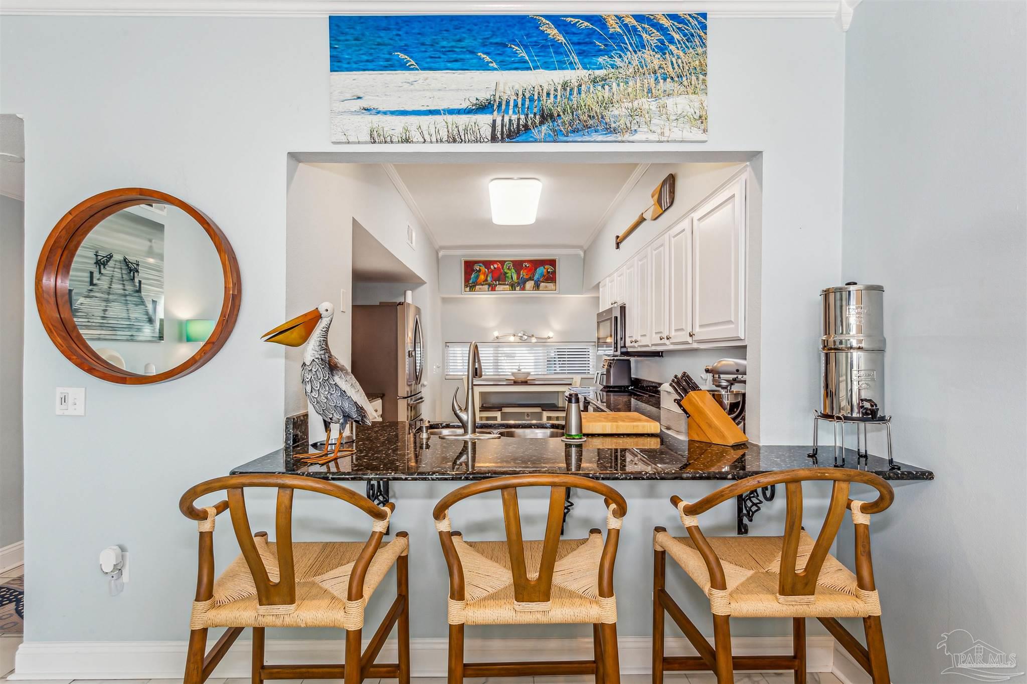 1390 Fort Pickens Road, Unit 116 Pensacola Beach, FL 32561 - Photo 14 of 37 a view of a dining room with furniture and a chandelier