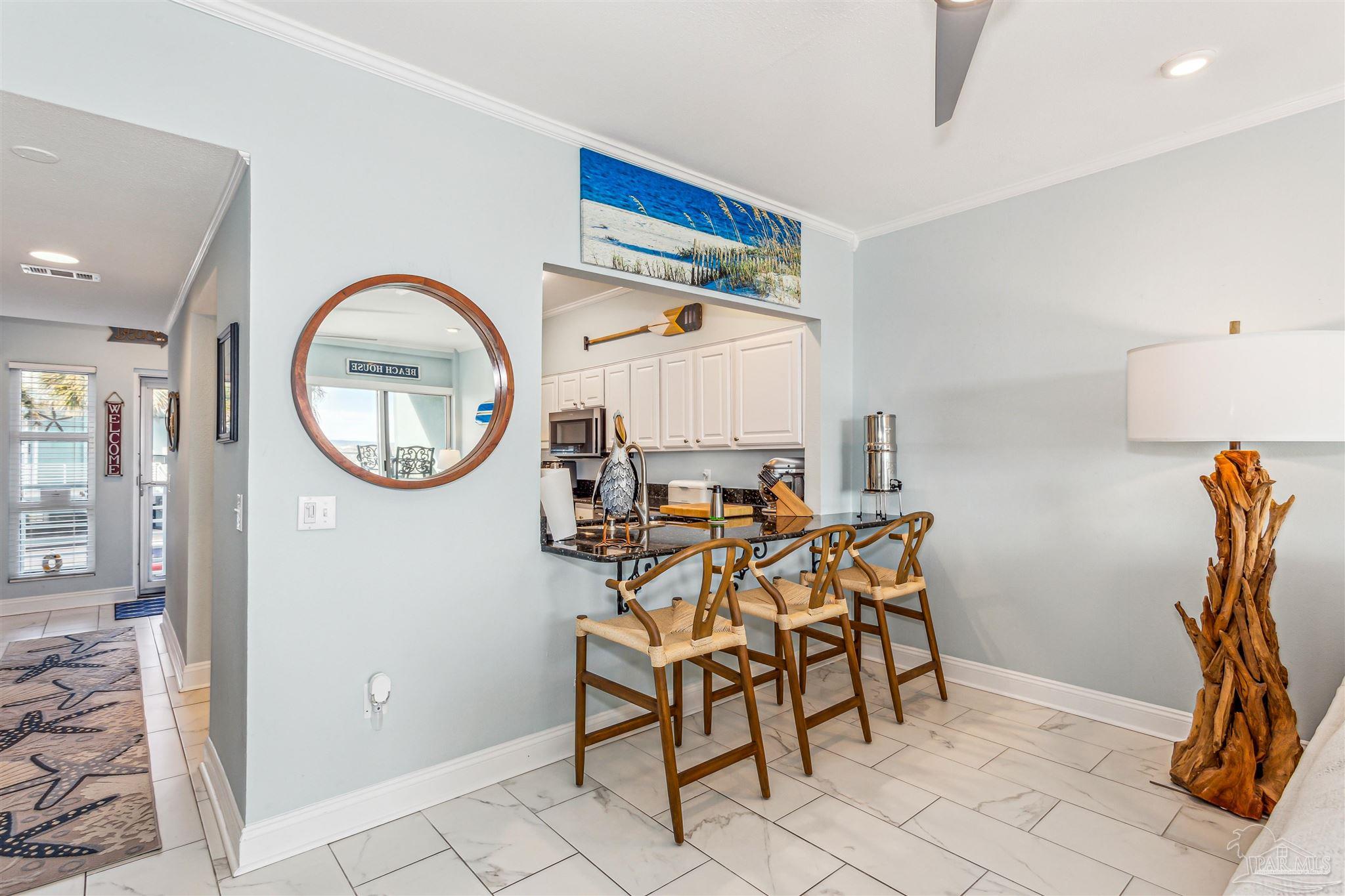 1390 Fort Pickens Road, Unit 116 Pensacola Beach, FL 32561 - Photo 15 of 37 a view of a livingroom with furniture and a mirror