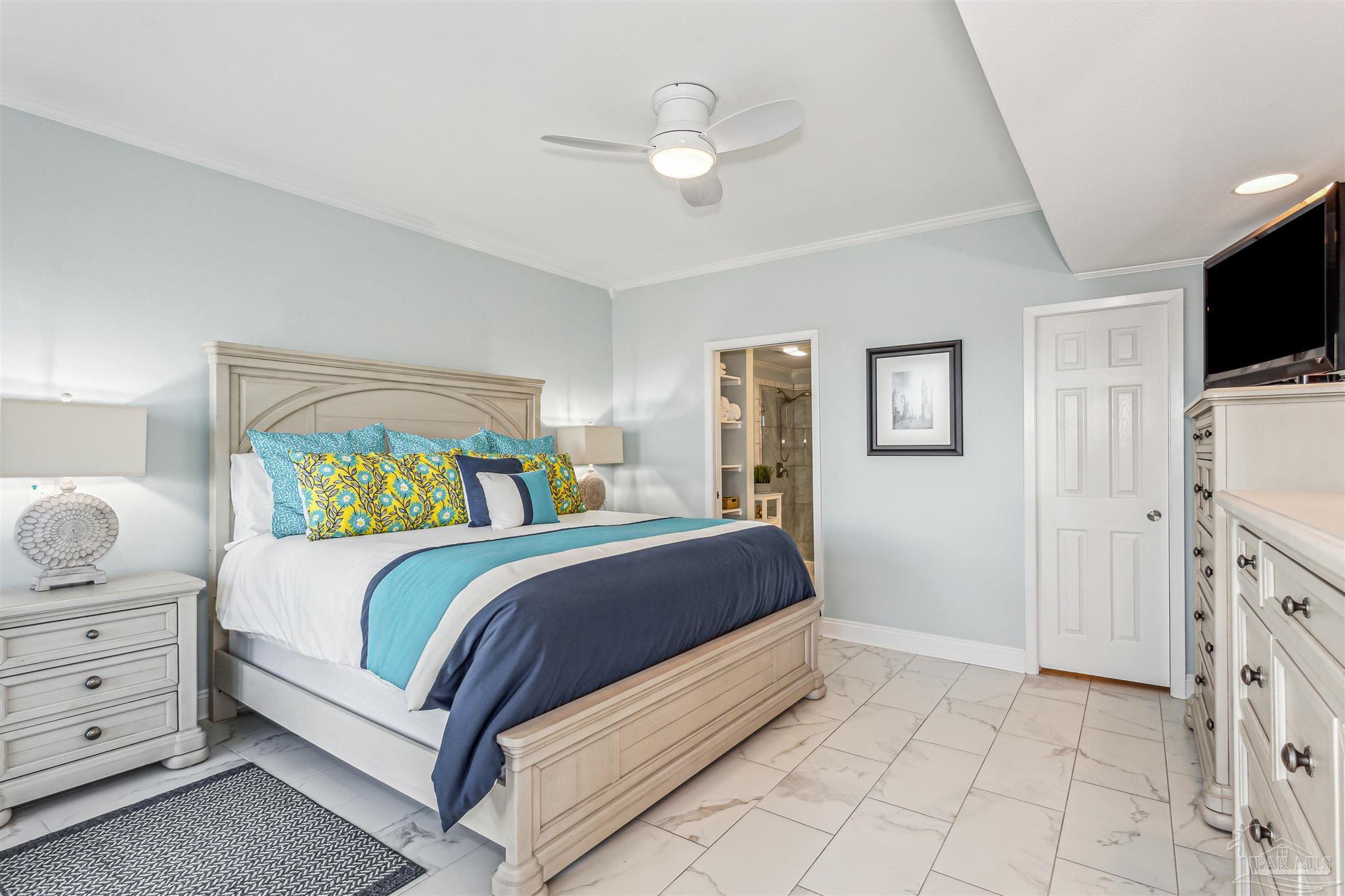 1390 Fort Pickens Road, Unit 116 Pensacola Beach, FL 32561 - Photo 22 of 37 a bed room with a bed and a television