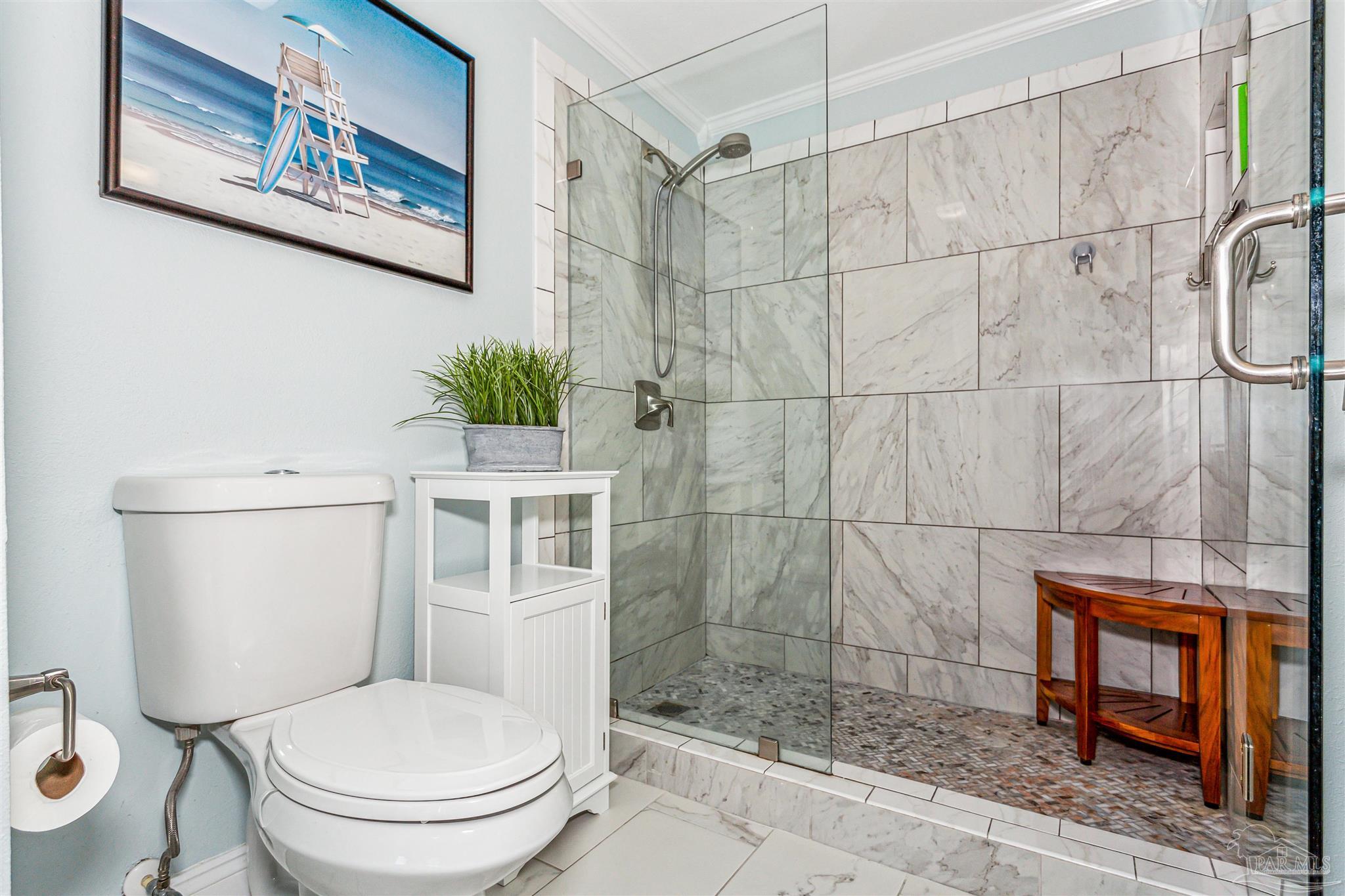 1390 Fort Pickens Road, Unit 116 Pensacola Beach, FL 32561 - Photo 26 of 37 a white toilet sitting next to a bathroom sink