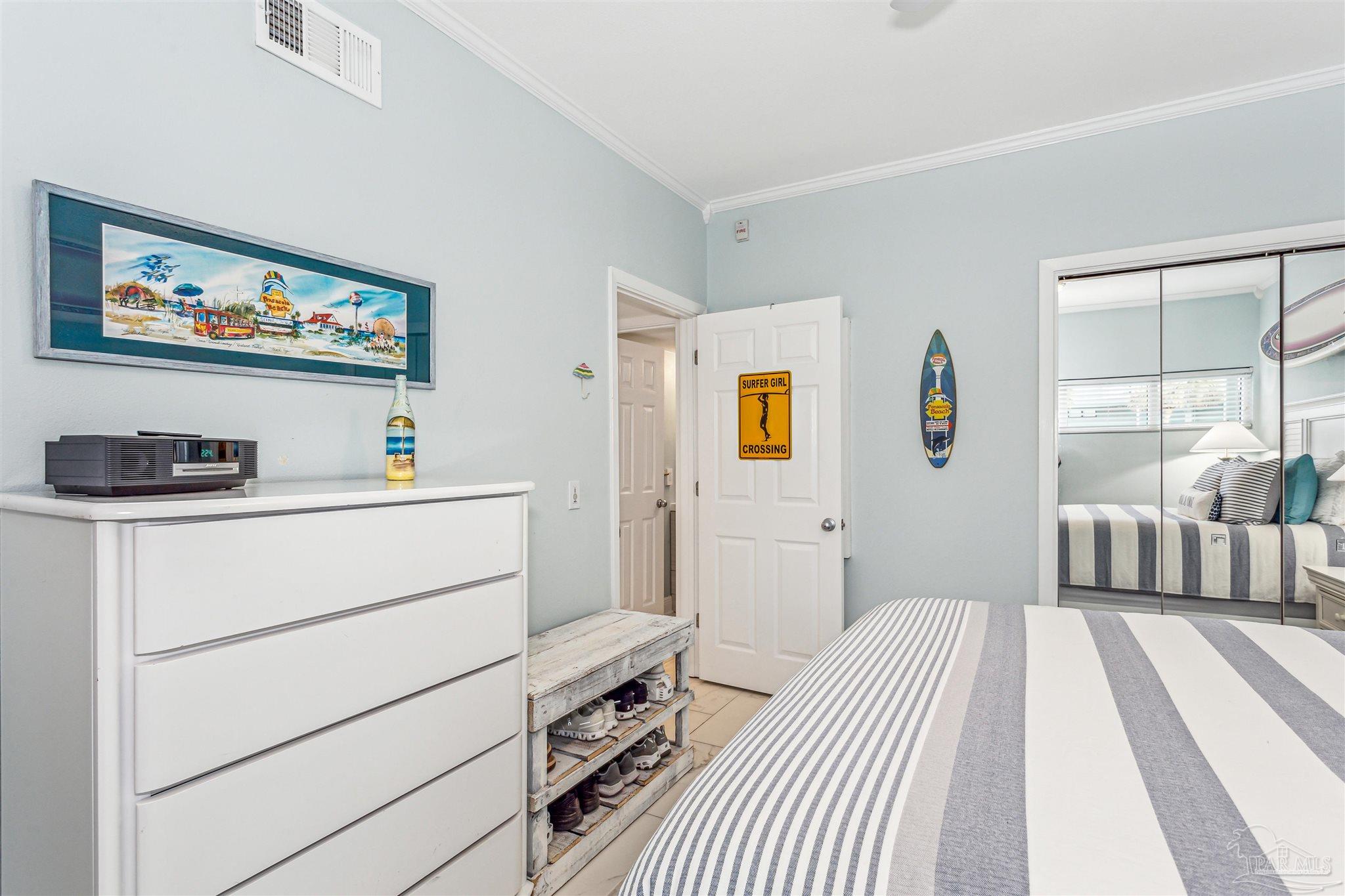 1390 Fort Pickens Road, Unit 116 Pensacola Beach, FL 32561 - Photo 28 of 37 a bedroom with a bed and a couch