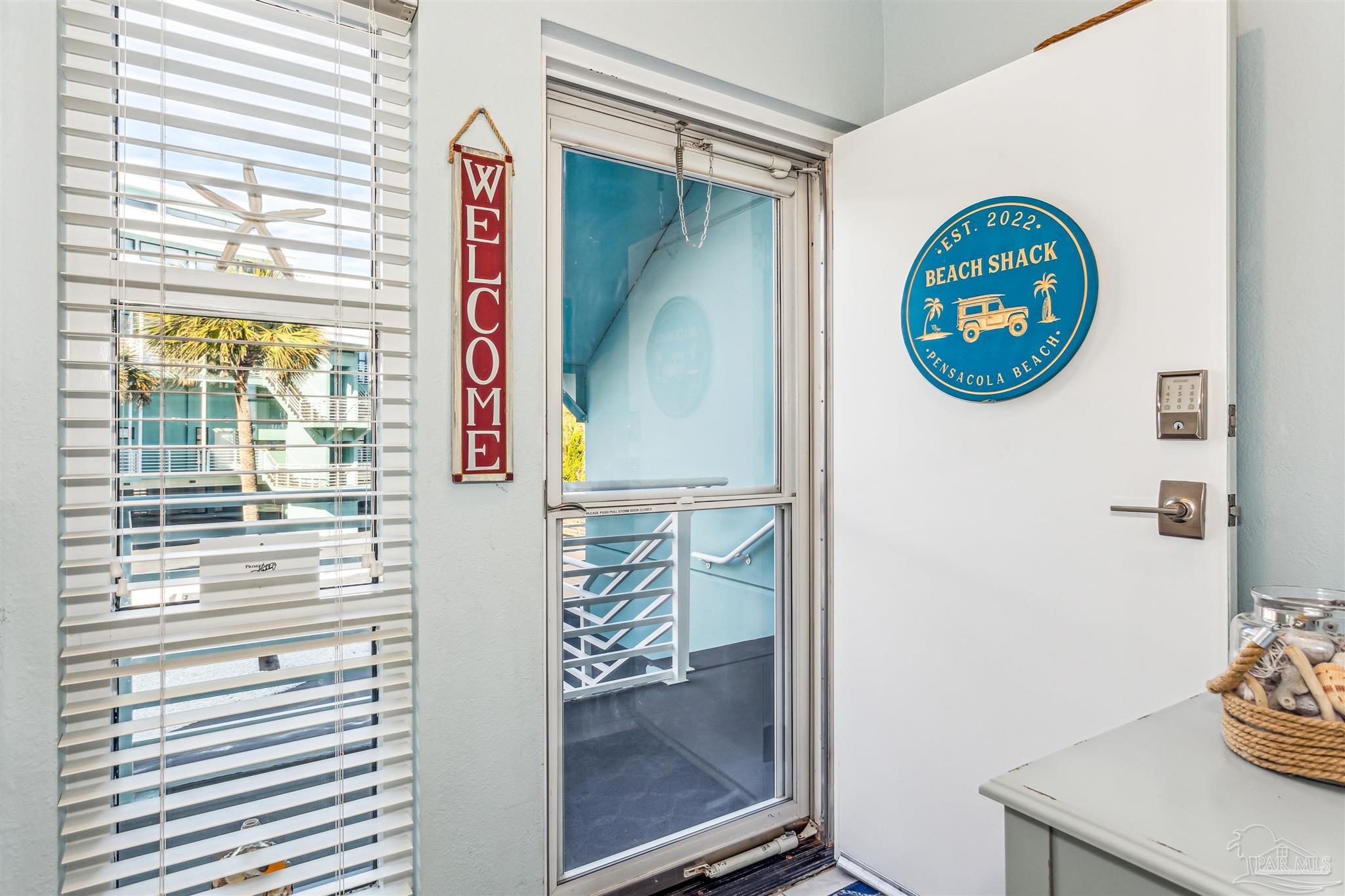 1390 Fort Pickens Road, Unit 116 Pensacola Beach, FL 32561 - Photo 4 of 37 a view of a door and chair