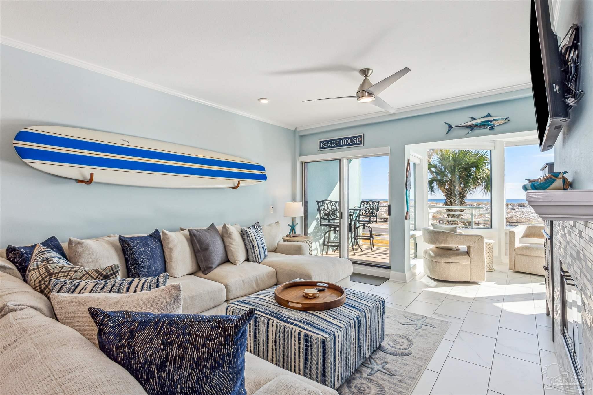 1390 Fort Pickens Road, Unit 116 Pensacola Beach, FL 32561 - Photo 7 of 37 a living room with furniture and a flat screen tv