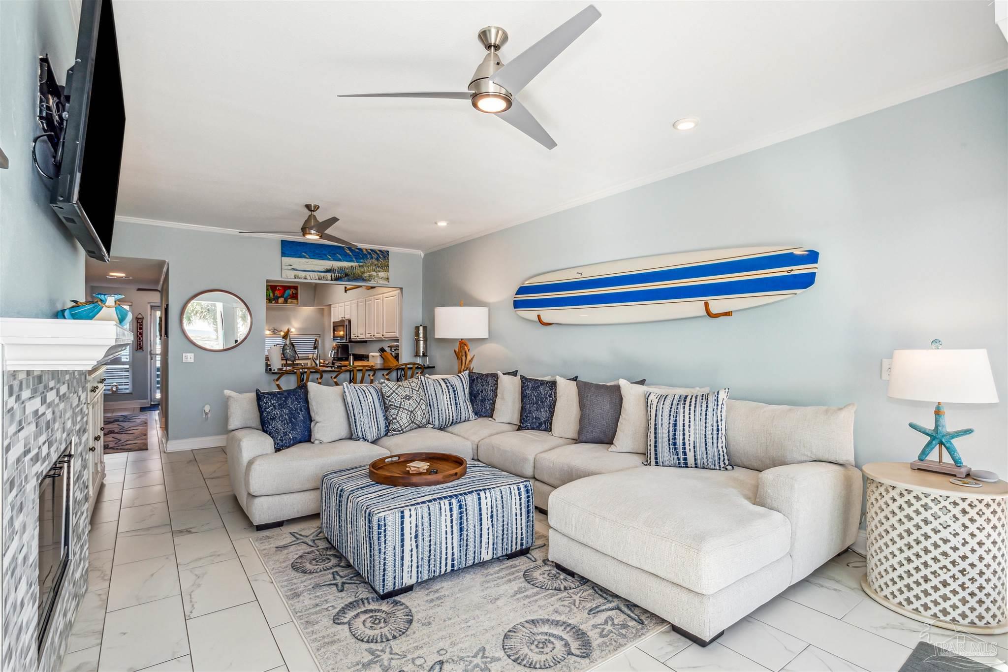1390 Fort Pickens Road, Unit 116 Pensacola Beach, FL 32561 - Photo 10 of 37 a living room with furniture and a flat screen tv