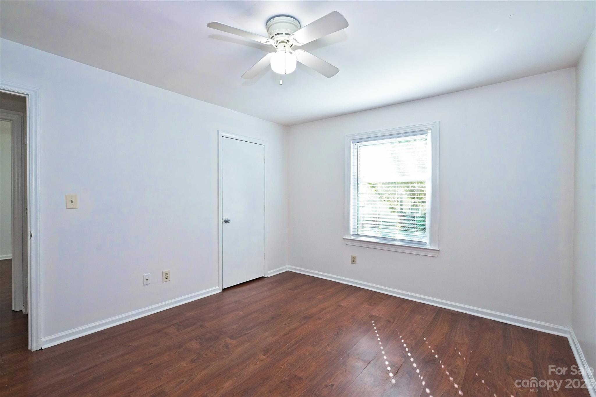 430 Queens Road, Unit 612 Charlotte, NC 28207 - Photo 18 of 22 wooden floor in an empty room with a window