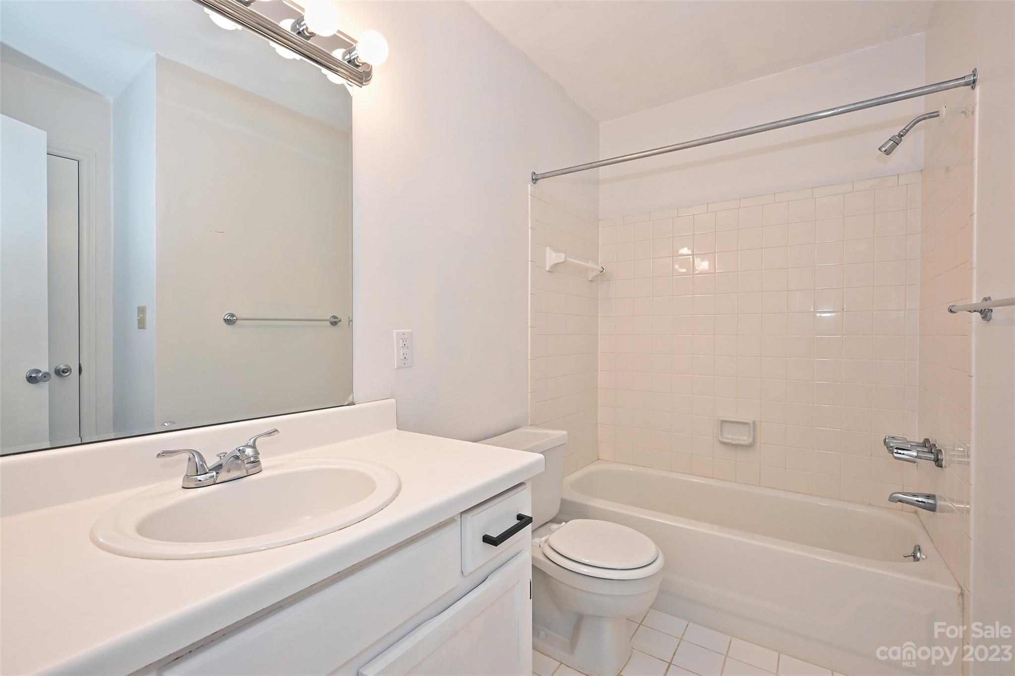 430 Queens Road, Unit 612 Charlotte, NC 28207 - Photo 19 of 22 a bathroom with a sink a toilet and shower