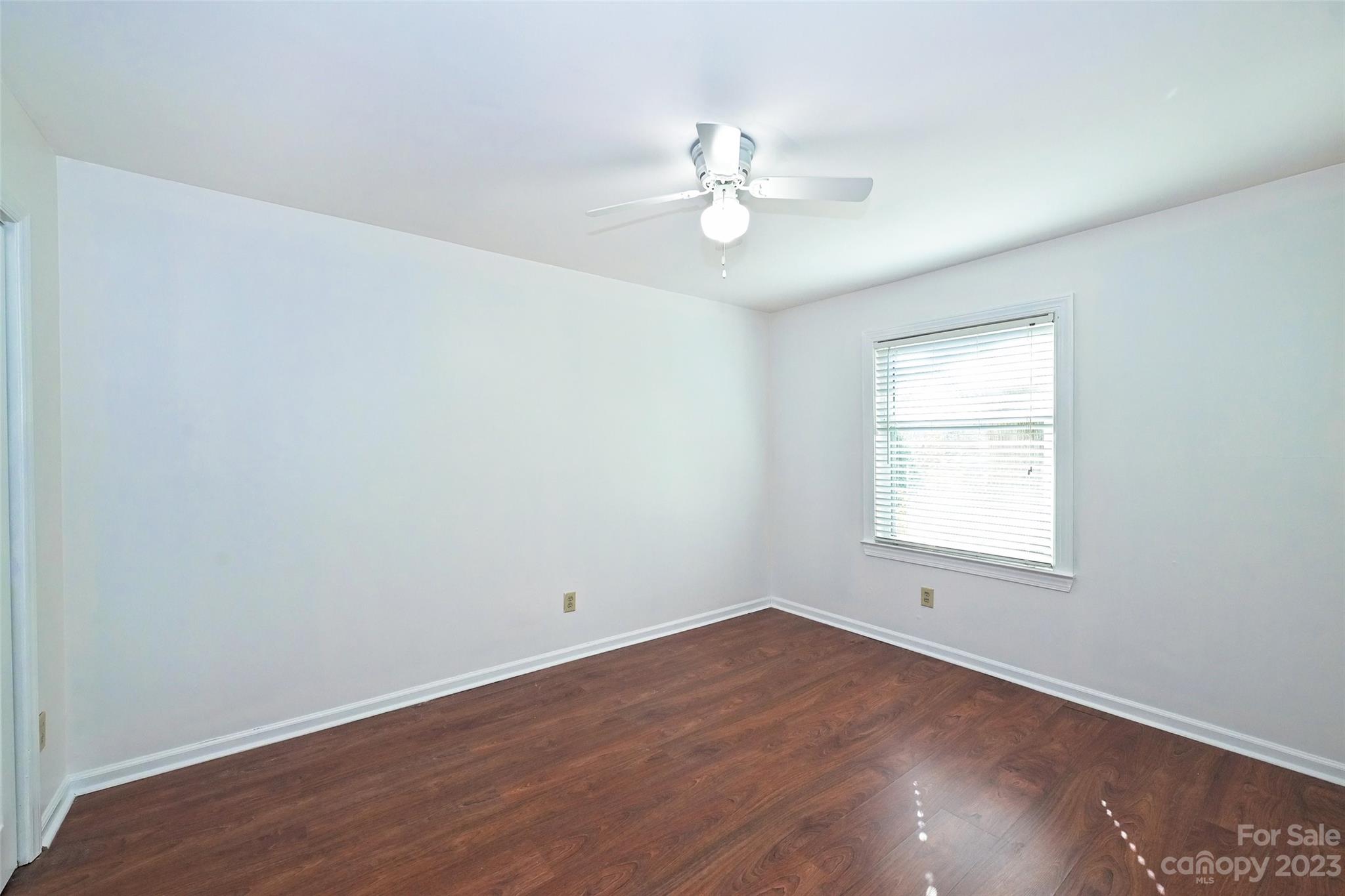 430 Queens Road, Unit 612 Charlotte, NC 28207 - Photo 20 of 22 an empty room with wooden floor and windows