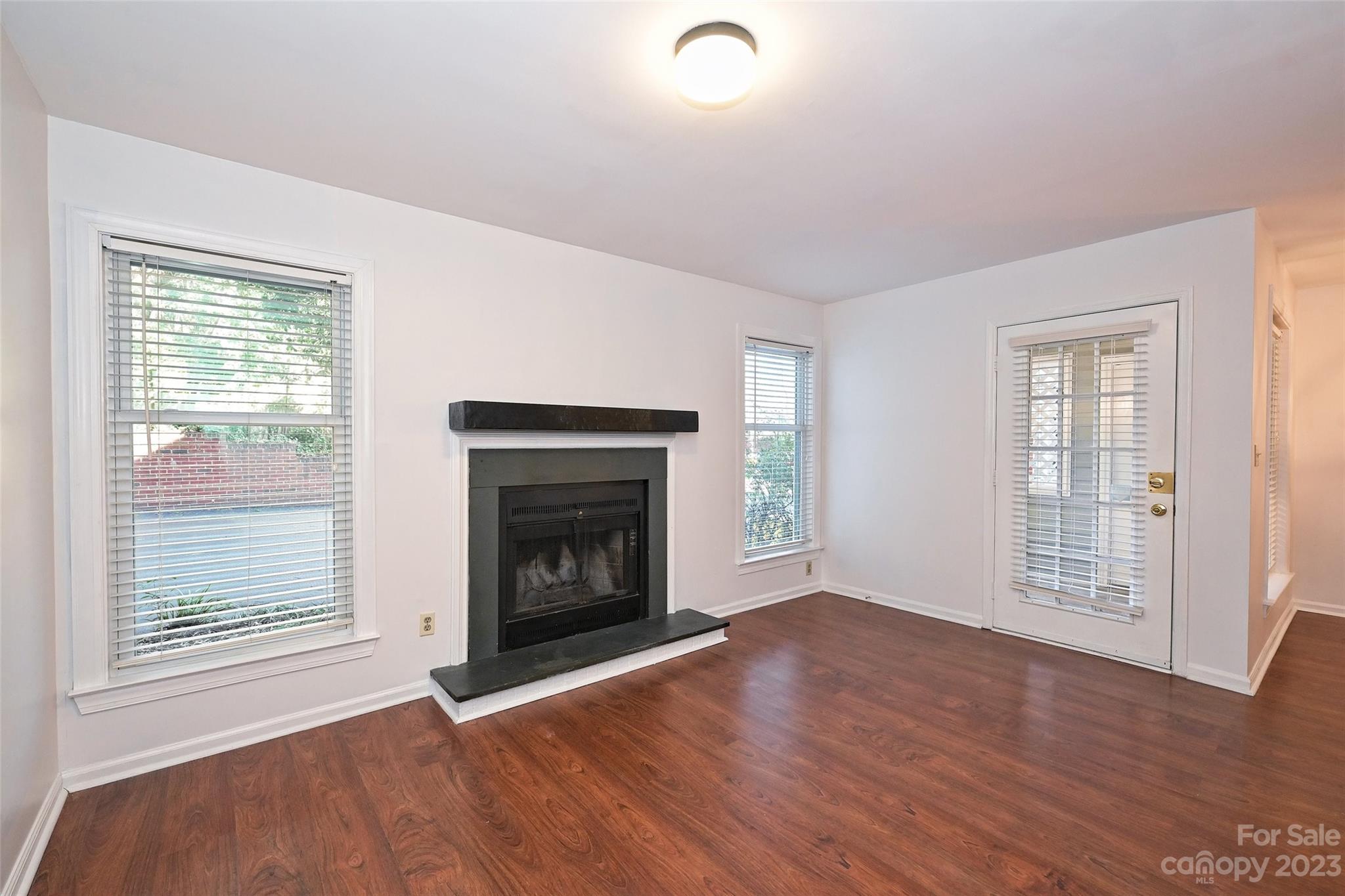 430 Queens Road, Unit 612 Charlotte, NC 28207 - Photo 5 of 22 an empty room with windows and fireplace