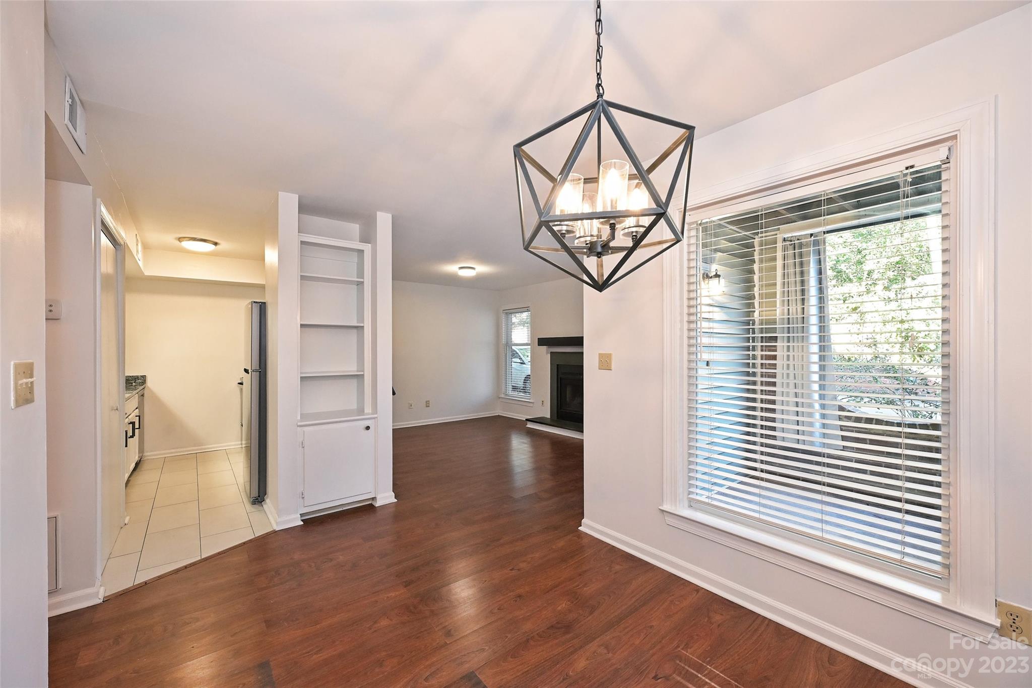 430 Queens Road, Unit 612 Charlotte, NC 28207 - Photo 10 of 22 a view of a livingroom with wooden floor and a window