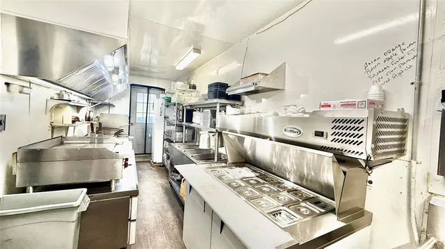 a living room with lots of furniture and white appliances