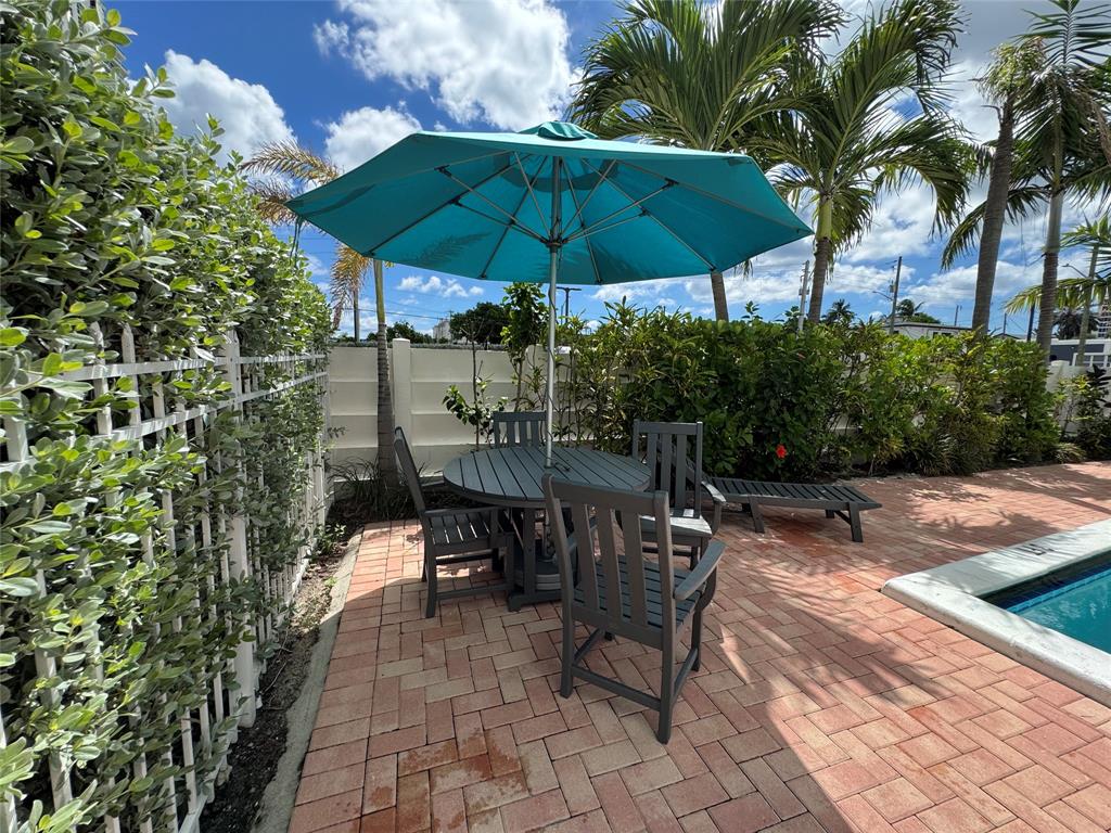 200 South Birch Road, Unit 806 Fort Lauderdale, FL 33316 - Photo 12 of 20 a view of a patio with a table and chairs under an umbrella