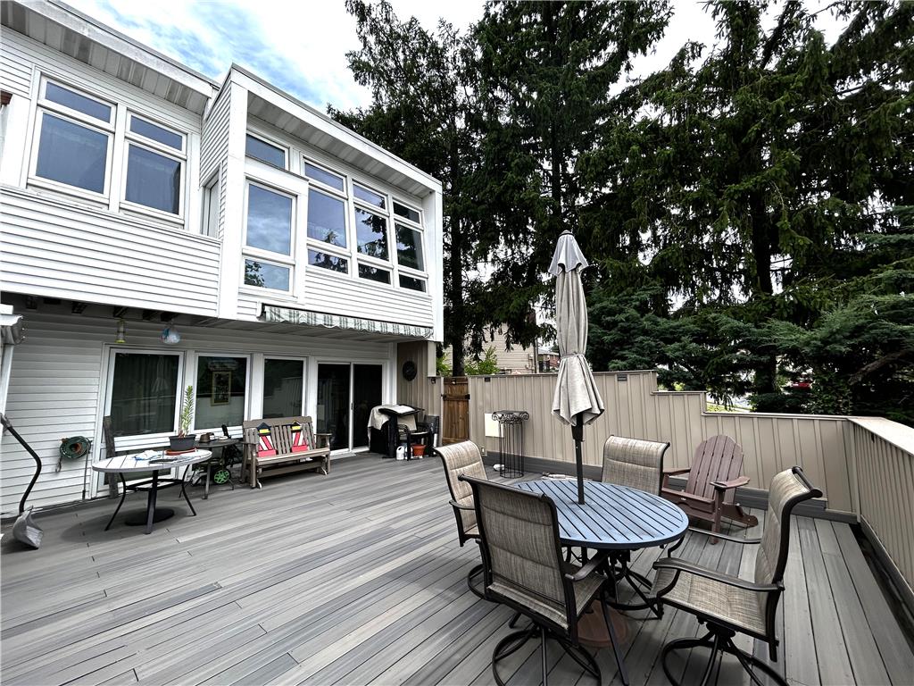 1214 Stanford Road Bethlehem, PA 18018 - Photo 8 of 58 An inviting outdoor deck provides an ideal space for relaxation and entertaining amidst lush greenery.