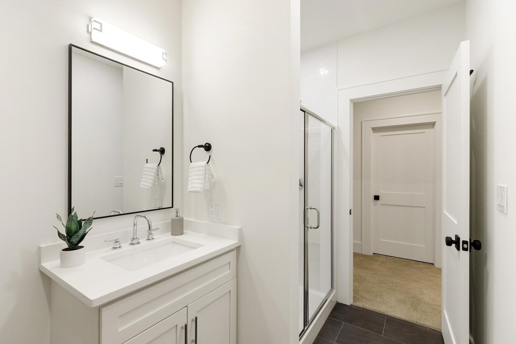 1124 Chestnut Street Newton, MA 02464 - Photo 31 of 41 a bathroom with a sink and a mirror