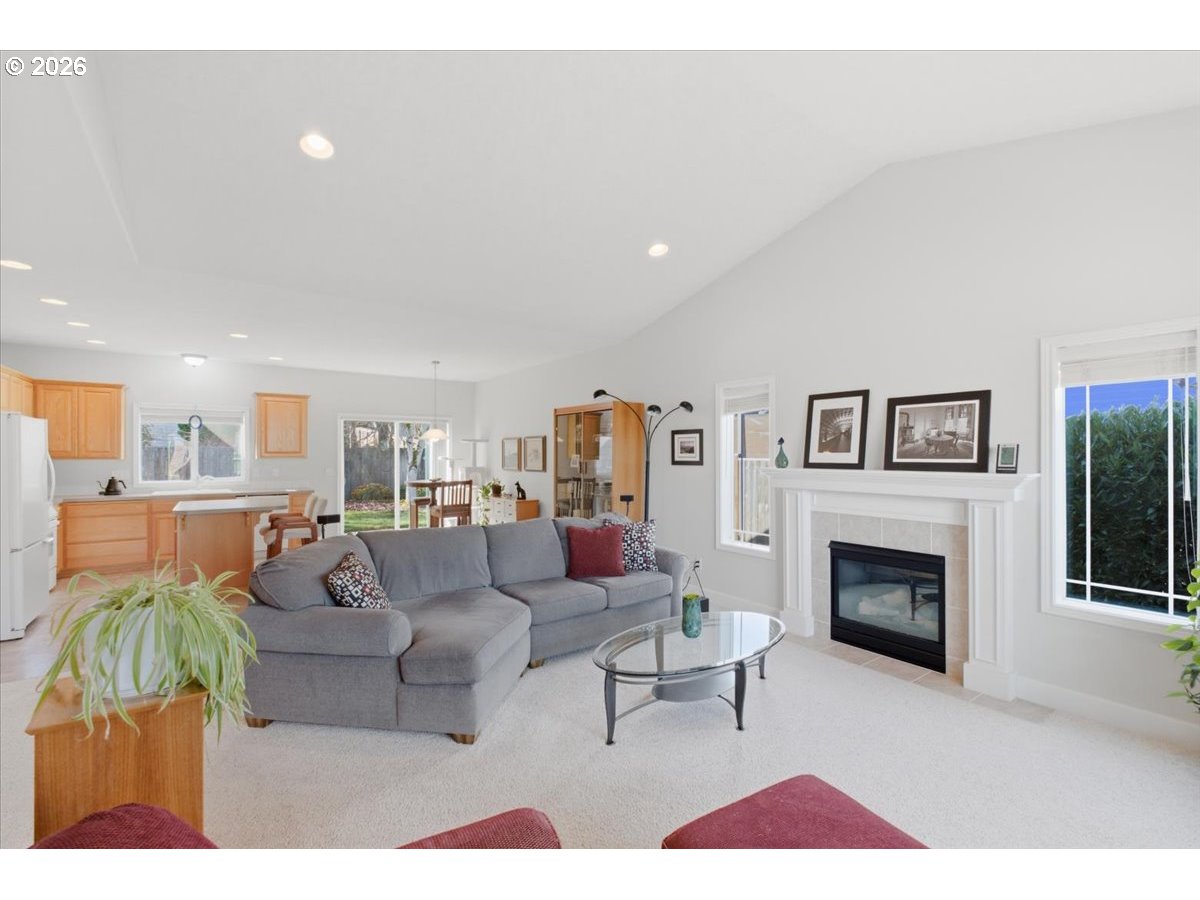 2066 Northwest Violet Avenue Albany, OR 97321 - Photo 11 of 48 a living room with furniture a fireplace and a flat screen tv