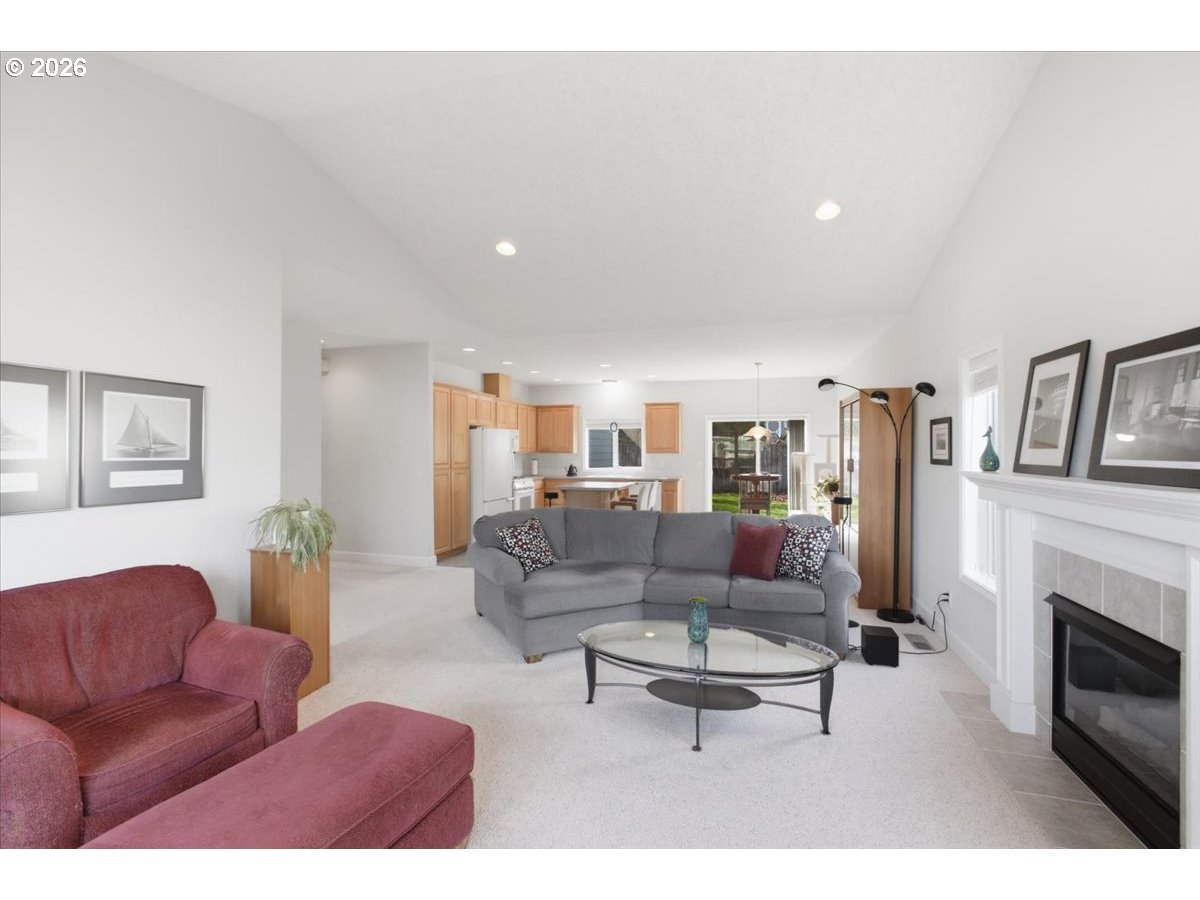 2066 Northwest Violet Avenue Albany, OR 97321 - Photo 12 of 48 a living room with furniture a fireplace and a flat screen tv