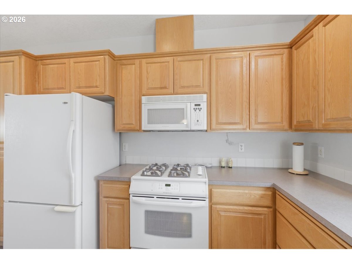 2066 Northwest Violet Avenue Albany, OR 97321 - Photo 17 of 48 a kitchen with stainless steel appliances white cabinets and a refrigerator