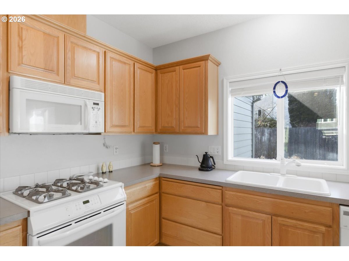 2066 Northwest Violet Avenue Albany, OR 97321 - Photo 18 of 48 a kitchen with stainless steel appliances granite countertop a sink stove and cabinets
