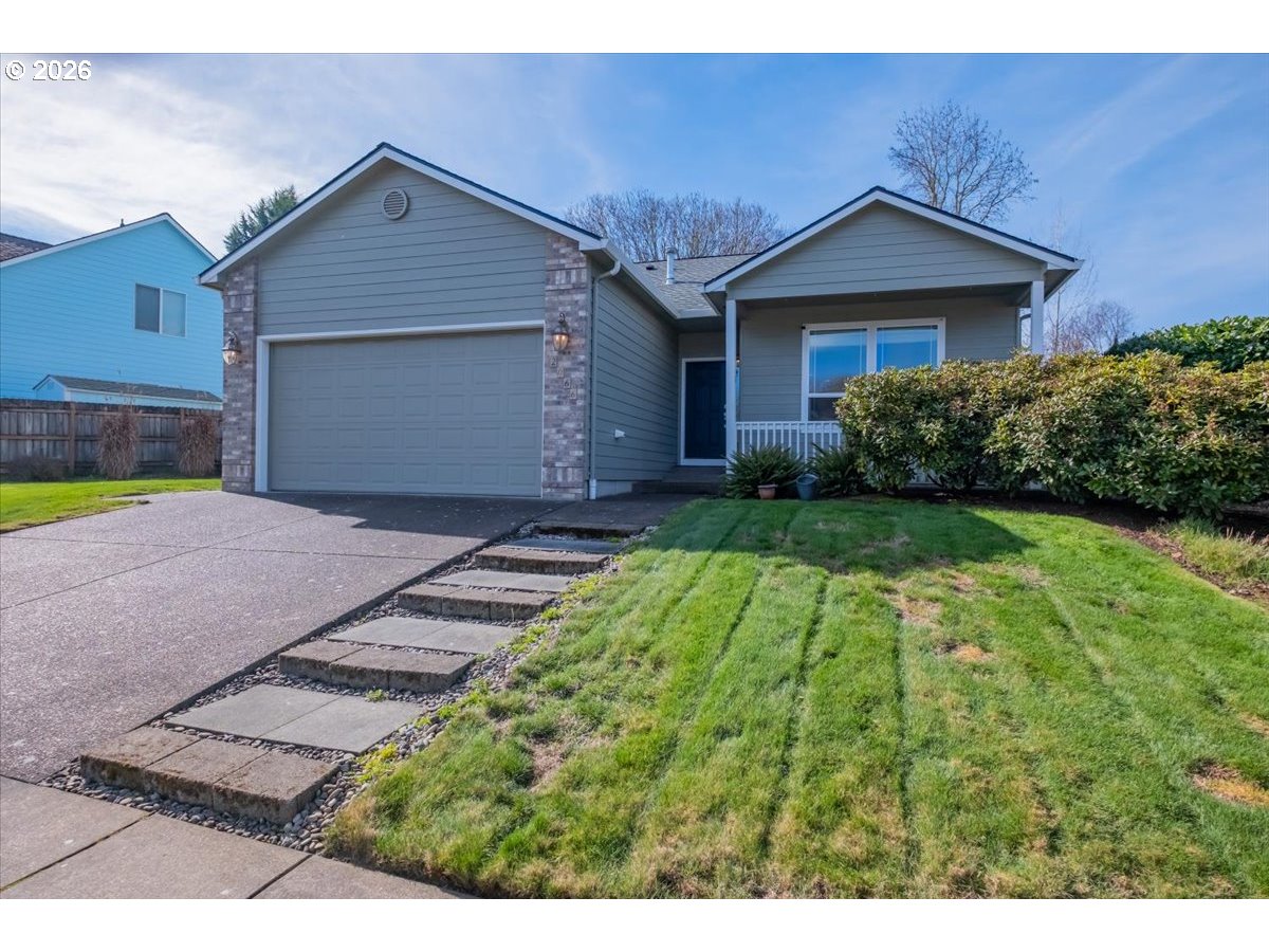 2066 Northwest Violet Avenue Albany, OR 97321 - Photo 2 of 48 a front view of a house with a yard and garage