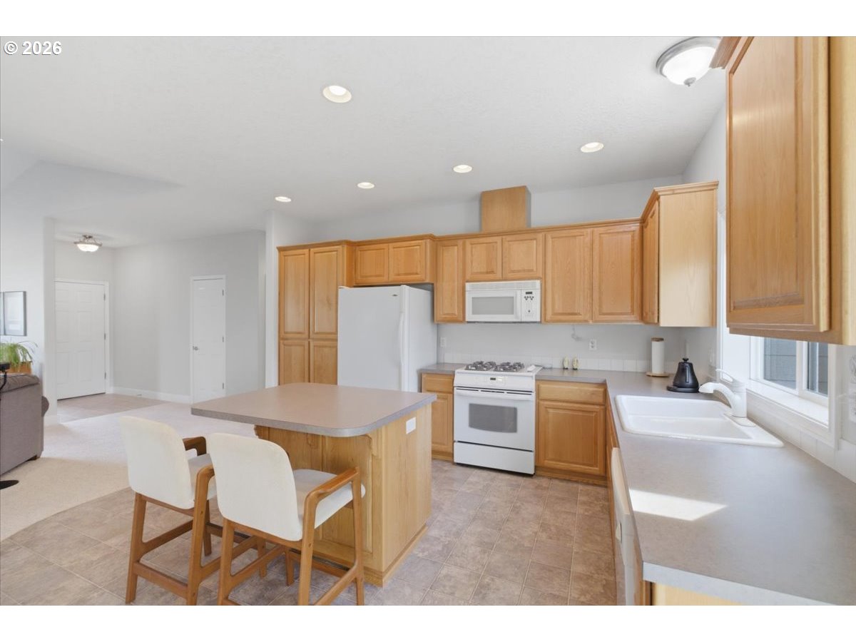 2066 Northwest Violet Avenue Albany, OR 97321 - Photo 21 of 48 a kitchen with stainless steel appliances kitchen island granite countertop a sink and cabinets