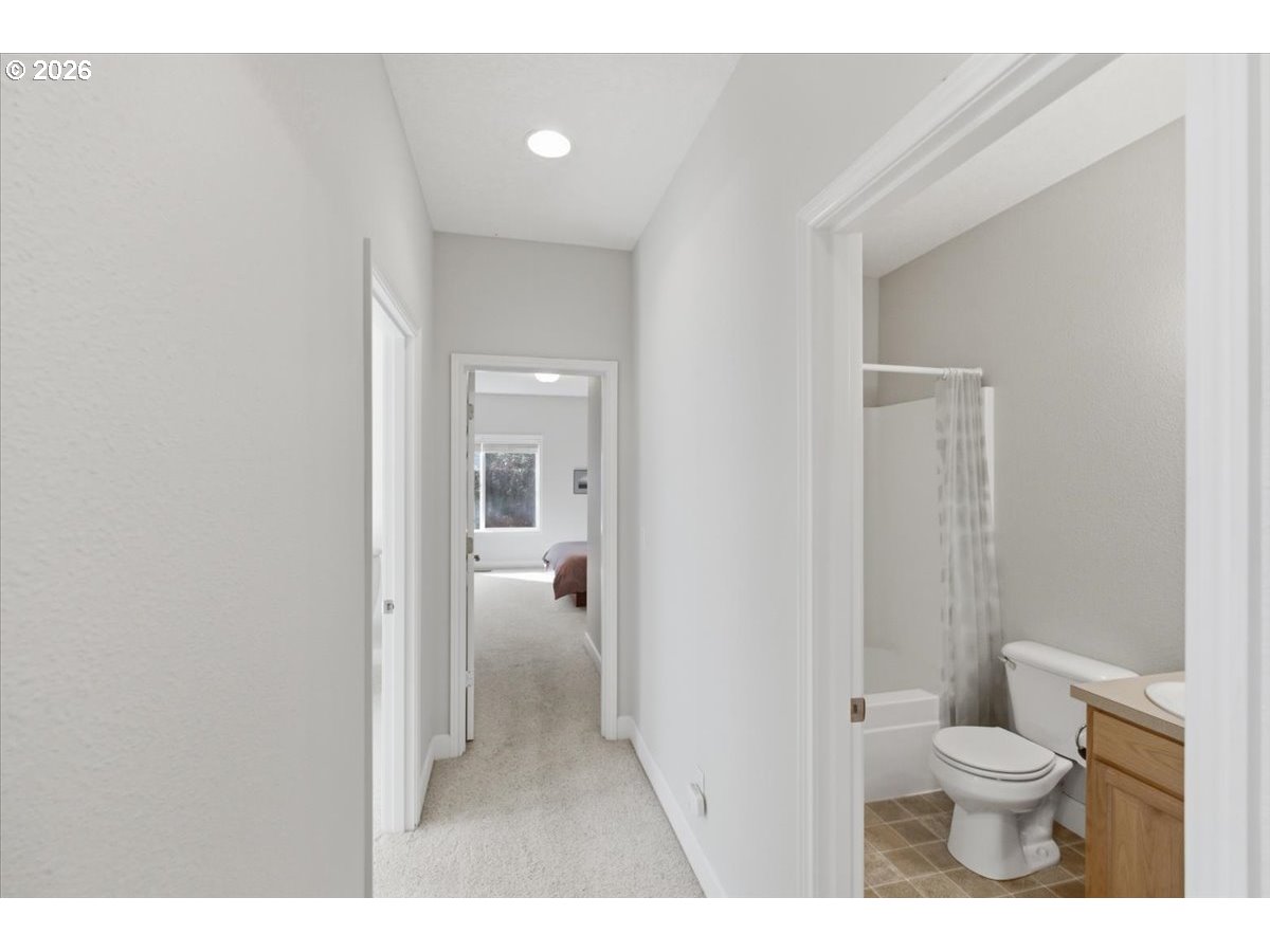 2066 Northwest Violet Avenue Albany, OR 97321 - Photo 28 of 48 a bathroom with a granite countertop toilet a sink and a mirror