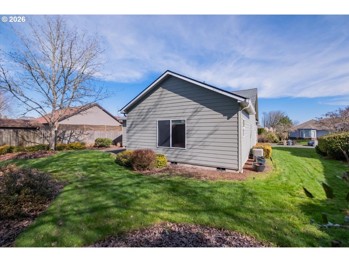 2066 Northwest Violet Avenue Albany, OR 97321 - Photo 44 of 48 a backyard of a house with plants and wooden fence